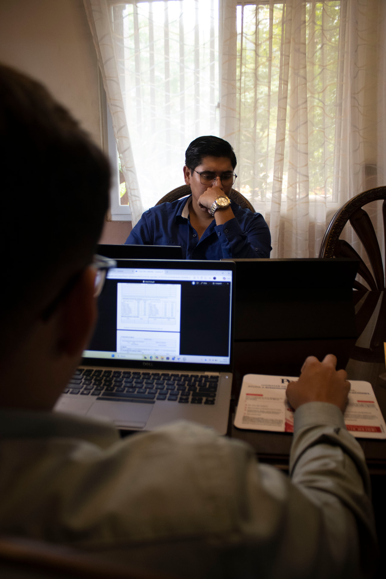 Reunión de trabajo revisando documentos y cifras de un contrato